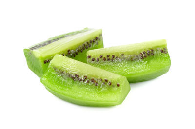 Close-up of green fruit against white background