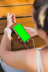 Midsection of woman using mobile phone