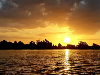 Scenic view of lake against sky during sunset