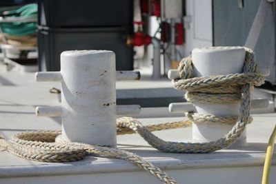 Close-up of ropes tied to bollards