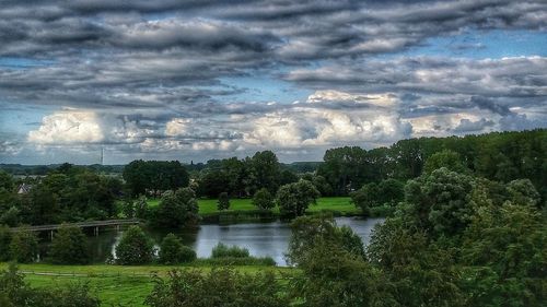 View of trees against cloudy sky