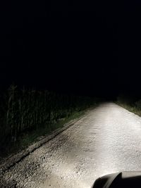 Road seen through car windshield at night