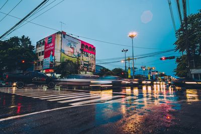 Cars on road against sky in city at night