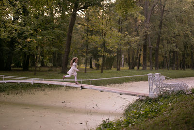 Beautiful little child girl walking in a park