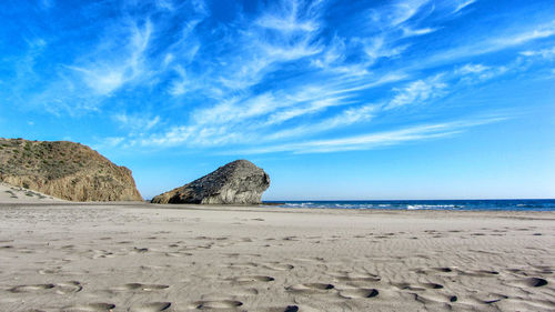 Scenic view of beach against blue sky