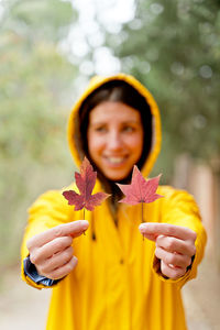 Smiling woman holding leaves