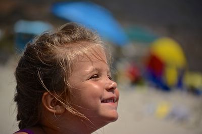 Close-up of smiling girl at beach