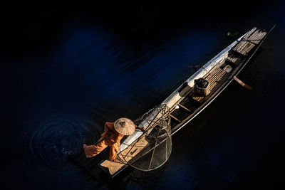 High angle view of fisherman with boat in river