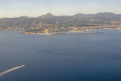 Scenic view of sea and mountains against sky