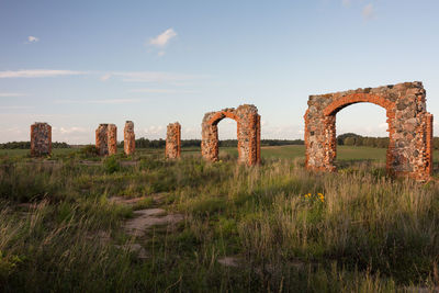 Old ruin on field against sky