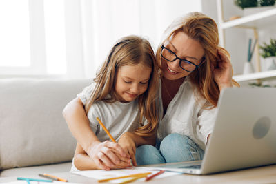 Young woman using laptop at home