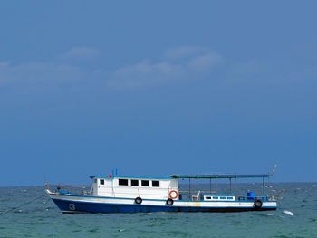 Boat sailing in sea against sky