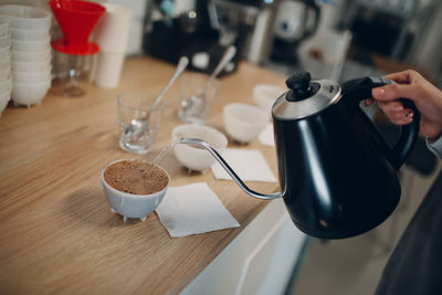 High angle view of woman pouring coffee