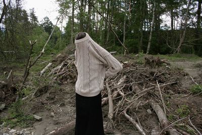 Man hanging on tree in forest