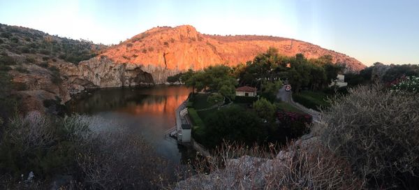 Scenic view of lake by trees against sky