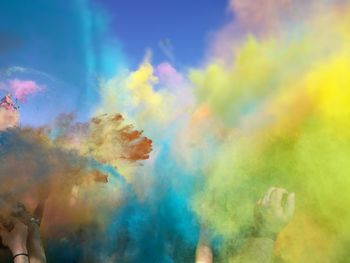 People splashing powder paints during holi celebration