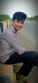 Portrait of young man sitting outdoors