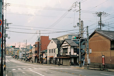 Road by buildings in city