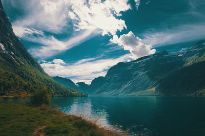 Scenic view of lake and mountains against sky