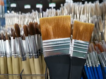 Close-up of paintbrushes in container