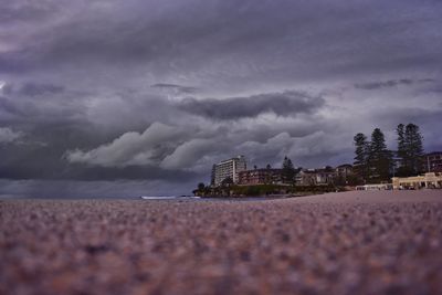 Surface level of buildings against cloudy sky