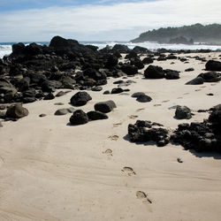 Rocks on beach against sky