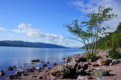 Scenic view of sea and mountains against sky