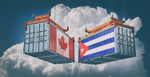 Low angle view of flag against building against sky