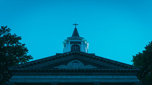 Low angle view of building against clear blue sky