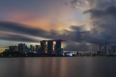 Illuminated buildings in city against sky at night