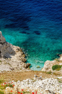 High angle view of rocks by sea