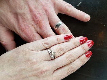 Cropped image of married couple with wedding ring on table