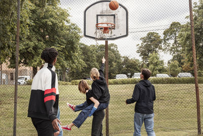 Teenagers playing basketball