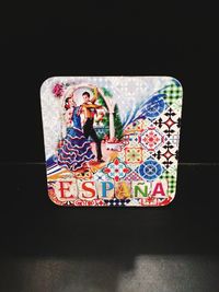 Close-up of painting on table against black background