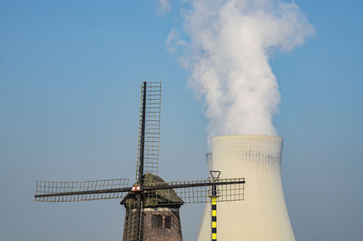 Low angle view of smoke stack against sky