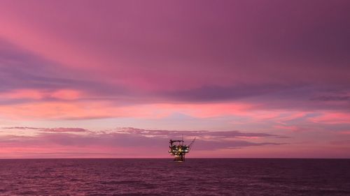 Scenic view of sea against orange sky