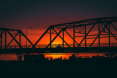 Silhouette of suspension bridge during sunset
