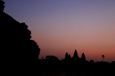 Silhouette temple against sky during sunset