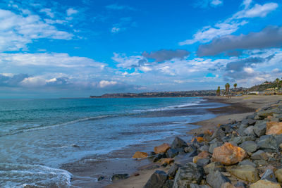 View of beach against cloudy sky