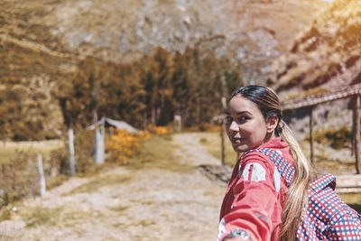 Young tourist walks on a path to the mountain. adventure travel, hiking concept