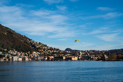 Scenic view of sea by town against sky