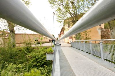 Low angle view of footbridge against trees