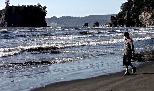 Boy walking at beach