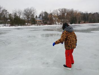 Rear view of woman on snow field