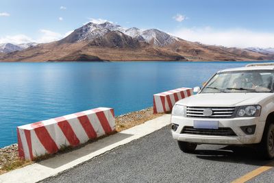 Scenic view of lake by mountains against sky