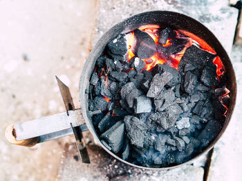 Directly above shot of burning coals in fire pit