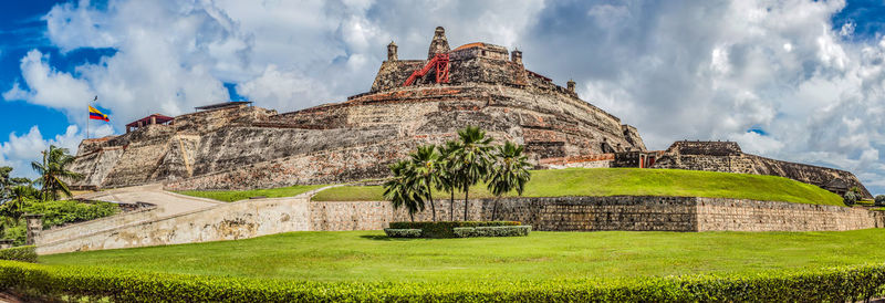 Ruins of temple against cloudy sky