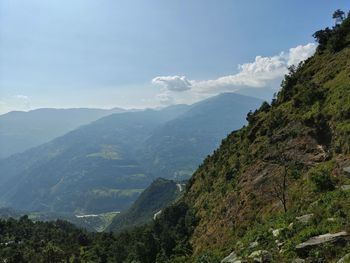 Scenic view of mountains against cloudy sky