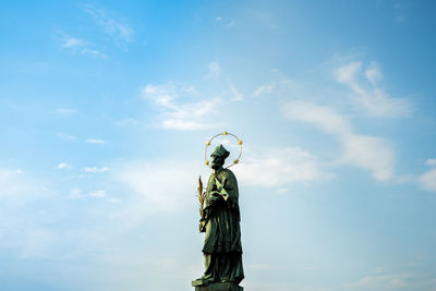 Low angle view of statue against blue sky