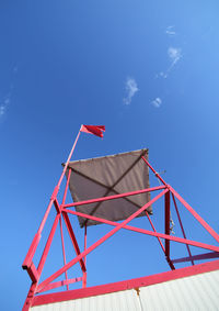 Low angle view of crane against blue sky